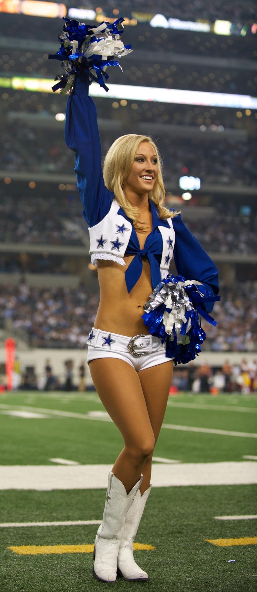 Blonde Cheerleader with Bare Legs wearing White Boots and Shorts
